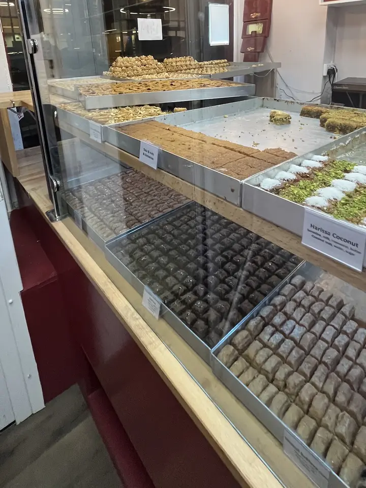 Rows of baklava and sweets in the glass display case