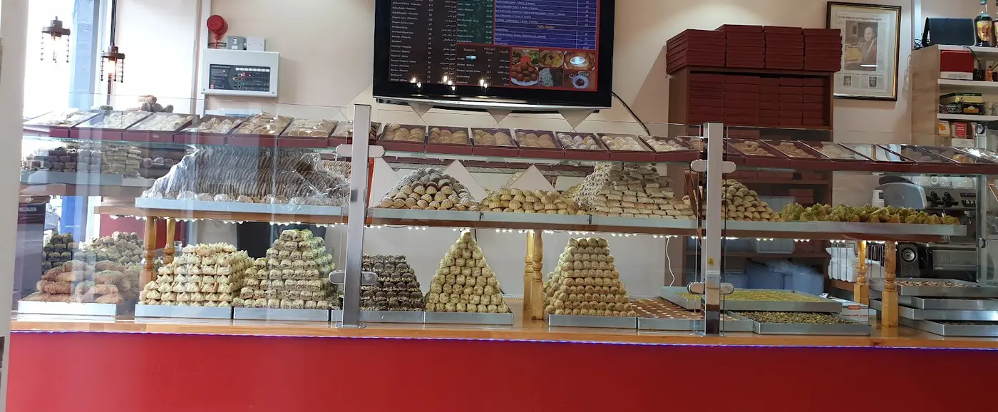Pyramids of fresh baklava and Syrian pastries in the display case at Levant Sweets, Edinburgh